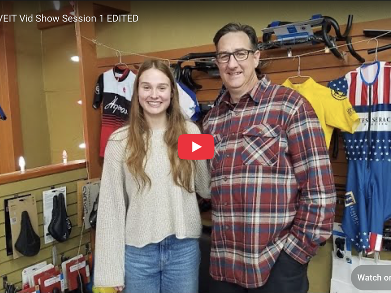 Title card for a YouTube/podcast: McKenna and her dad in a bike shop